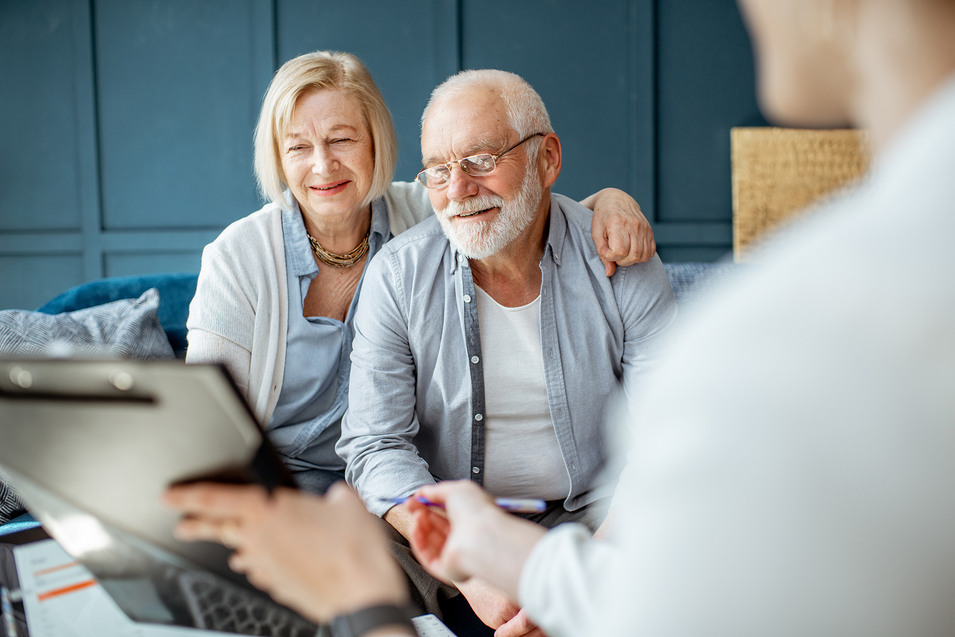Couple discussing estate planning with a financial advisor, focusing on future financial security and investments