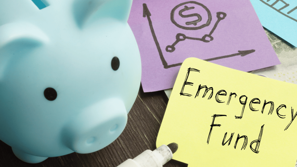 A piggy bank alongside sticky notes, one with a chart indicating financial growth and another with "Emergency Fund" written on it, suggesting financial planning and savings.